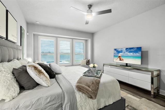 165 Azure Mist Way, Daytona Beach, FL 32124 - bedroom with dark wood-style flooring, a ceiling fan, a textured ceiling, and baseboards