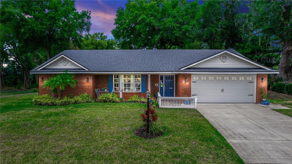 20 Monroe Ave, Debary, FL 32713 - ranch-style house with covered porch, brick siding, and a garage
