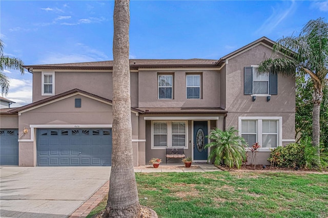 4604 Barbados Loop, Clermont, FL 34711 - traditional home with stucco siding, driveway, a front lawn, and an attached garage
