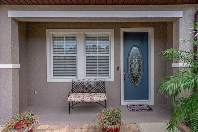 4604 Barbados Loop, Clermont, FL 34711 - doorway to property with stucco siding and covered porch