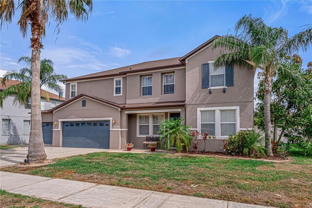 4604 Barbados Loop, Clermont, FL 34711 - traditional home with stucco siding, a front yard, concrete driveway, and a garage