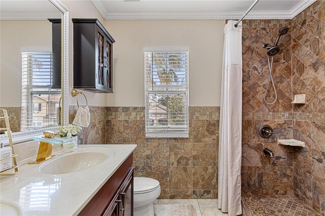 4604 Barbados Loop, Clermont, FL 34711 - full bath featuring a tile shower, plenty of natural light, vanity, tile walls, and a wainscoted wall
