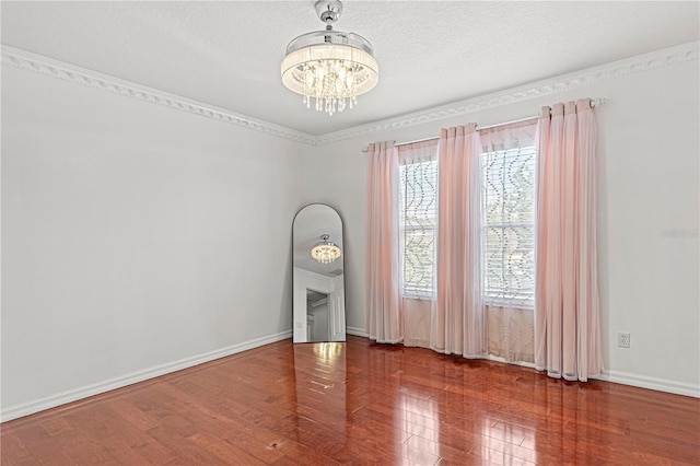 4604 Barbados Loop, Clermont, FL 34711 - spare room with a chandelier, baseboards, wood finished floors, and a textured ceiling