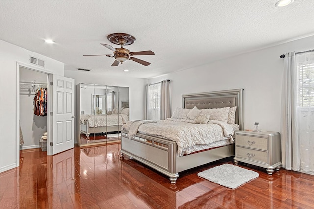 4604 Barbados Loop, Clermont, FL 34711 - bedroom with a textured ceiling, wood finished floors, a closet, a ceiling fan, and recessed lighting