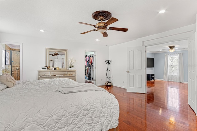 4604 Barbados Loop, Clermont, FL 34711 - bedroom featuring a walk in closet, baseboards, recessed lighting, wood finished floors, and a ceiling fan