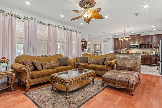 4604 Barbados Loop, Clermont, FL 34711 - living room featuring ceiling fan, crown molding, a chandelier, light wood-style floors, and recessed lighting