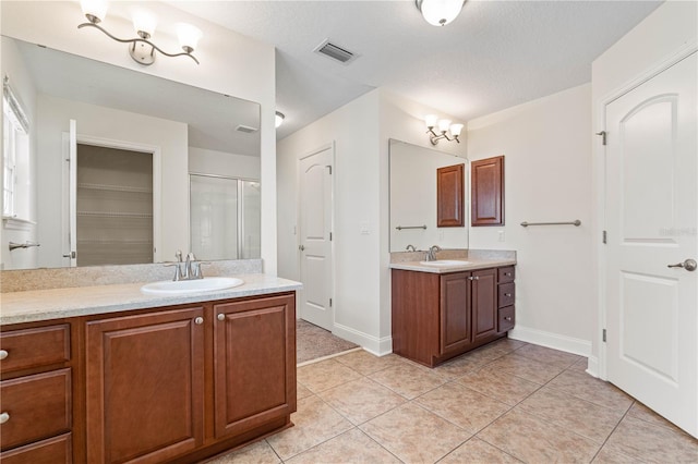 703 Elkhorn Fern Ln, Deland, FL 32720 - full bath with a stall shower, tile patterned flooring, two vanities, and baseboards