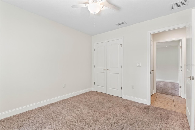 703 Elkhorn Fern Ln, Deland, FL 32720 - unfurnished bedroom featuring light carpet, a closet, baseboards, ceiling fan, and light tile patterned floors