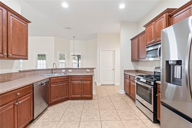 703 Elkhorn Fern Ln, Deland, FL 32720 - kitchen with appliances with stainless steel finishes, a sink, a peninsula, light tile patterned flooring, and recessed lighting