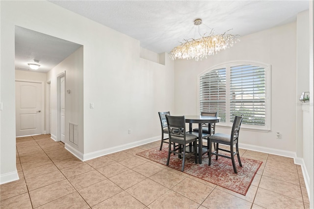 703 Elkhorn Fern Ln, Deland, FL 32720 - dining space with a chandelier, light tile patterned floors, and baseboards