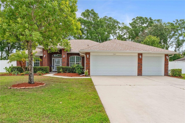 703 Elkhorn Fern Ln, Deland, FL 32720 - view of front facade featuring a garage, concrete driveway, and brick siding