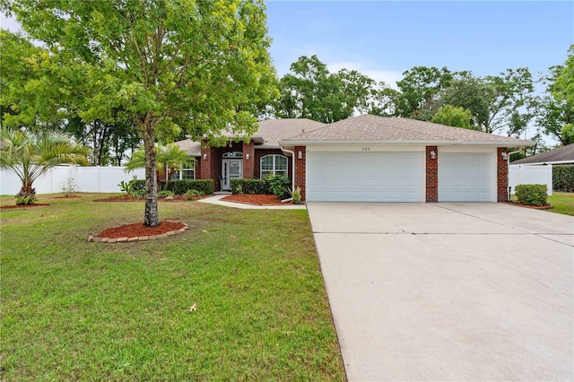 703 Elkhorn Fern Ln, Deland, FL 32720 - ranch-style home featuring concrete driveway, a garage, and brick siding