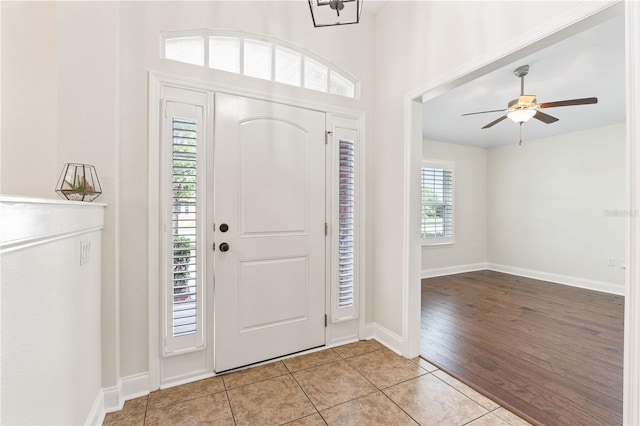 703 Elkhorn Fern Ln, Deland, FL 32720 - entrance foyer featuring light tile patterned flooring, ceiling fan, and baseboards