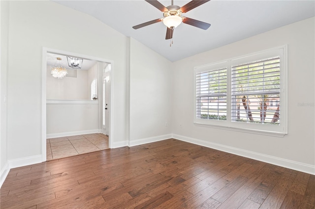 703 Elkhorn Fern Ln, Deland, FL 32720 - spare room with lofted ceiling, wood-type flooring, a chandelier, baseboards, and a ceiling fan