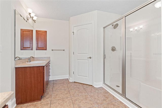 703 Elkhorn Fern Ln, Deland, FL 32720 - full bathroom featuring a shower stall, vanity, a textured ceiling, tile patterned floors, and baseboards