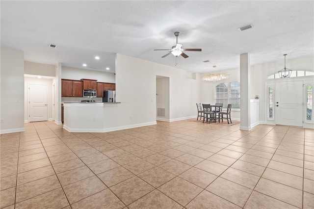 703 Elkhorn Fern Ln, Deland, FL 32720 - living room with light tile patterned floors, a chandelier, a ceiling fan, healthy amount of natural light, and recessed lighting