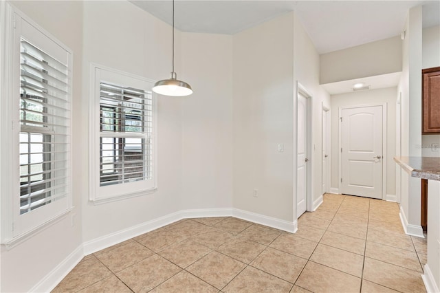 703 Elkhorn Fern Ln, Deland, FL 32720 - unfurnished dining area with light tile patterned floors and baseboards