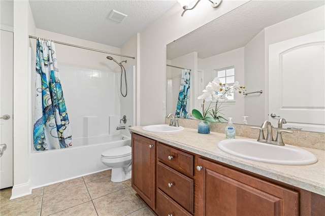 703 Elkhorn Fern Ln, Deland, FL 32720 - full bath with tile patterned floors, shower / bath combination with curtain, double vanity, toilet, and a textured ceiling
