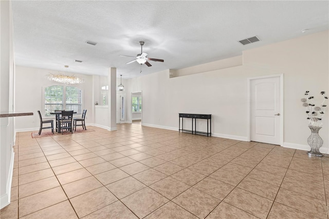 703 Elkhorn Fern Ln, Deland, FL 32720 - spare room with a ceiling fan, light tile patterned flooring, a chandelier, baseboards, and a textured ceiling
