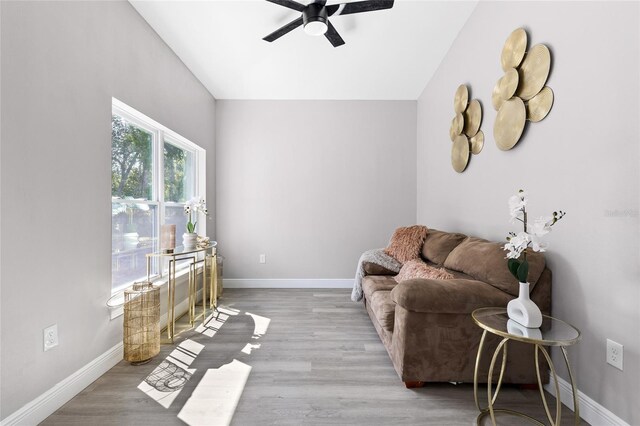 1738 Palm Rd, Ormond Beach, FL 32174 - living area featuring a ceiling fan, baseboards, and wood finished floors