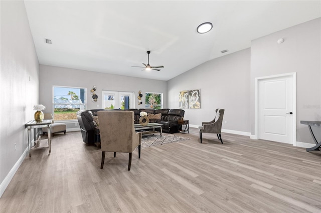 1738 Palm Rd, Ormond Beach, FL 32174 - living area with vaulted ceiling, a ceiling fan, light wood-style floors, and baseboards
