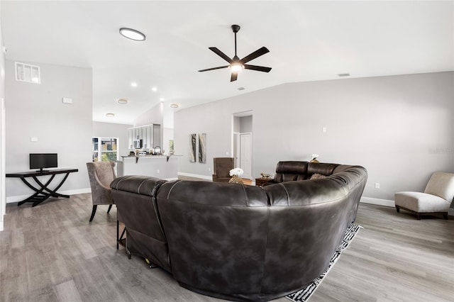 1738 Palm Rd, Ormond Beach, FL 32174 - living room featuring light wood finished floors, vaulted ceiling, ceiling fan, baseboards, and recessed lighting