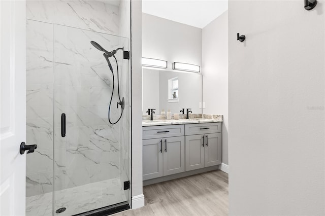 1738 Palm Rd, Ormond Beach, FL 32174 - full bath with a marble finish shower, wood finished floors, baseboards, and double vanity
