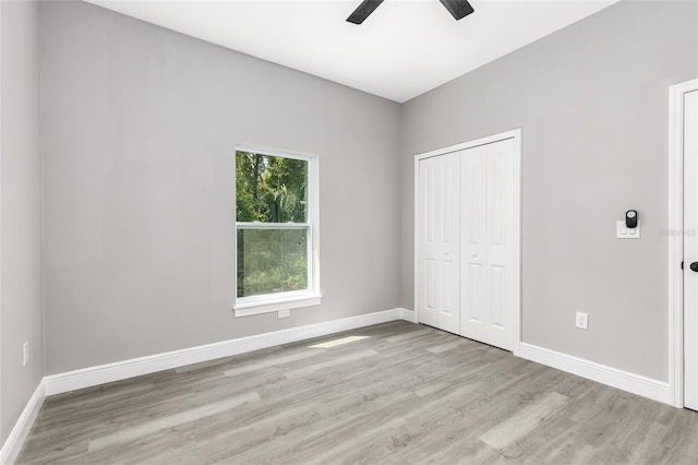 1738 Palm Rd, Ormond Beach, FL 32174 - unfurnished bedroom with wood finished floors, baseboards, a closet, and ceiling fan