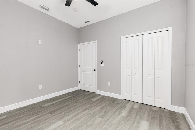 1738 Palm Rd, Ormond Beach, FL 32174 - unfurnished bedroom with light wood finished floors, baseboards, a closet, and a ceiling fan