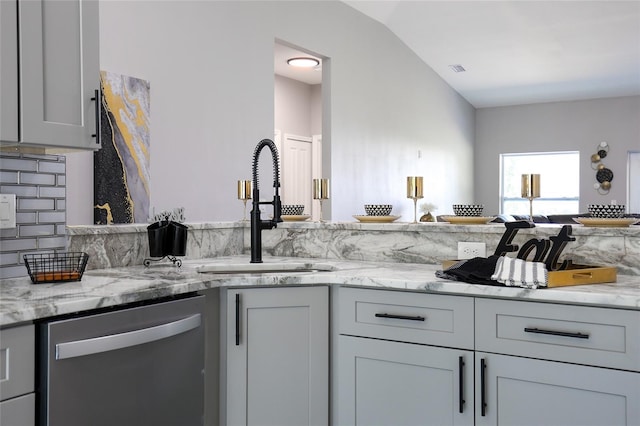 1738 Palm Rd, Ormond Beach, FL 32174 - kitchen featuring stainless steel dishwasher, a sink, light stone counters, and vaulted ceiling