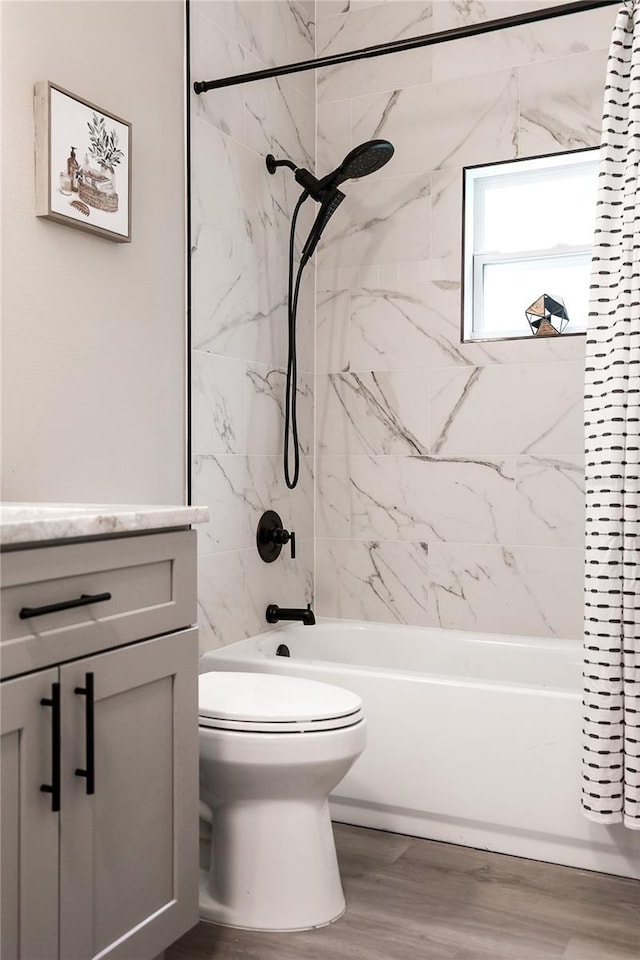 1738 Palm Rd, Ormond Beach, FL 32174 - full bathroom featuring shower / bath combination, toilet, vanity, and wood finished floors