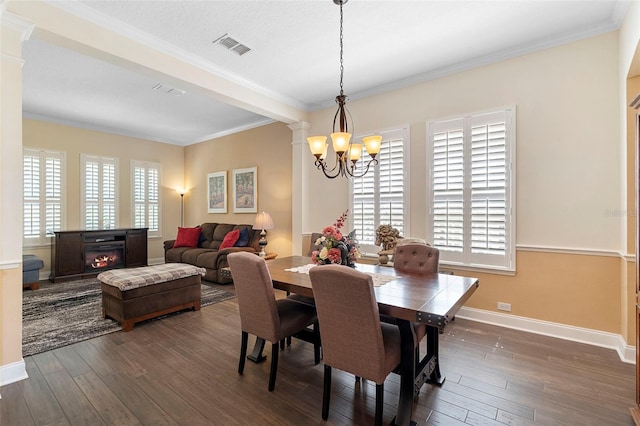 123 Ivydale Manor Dr, Deland, FL 32724 - dining area featuring a chandelier, dark wood-style floors, ornamental molding, baseboards, and ornate columns