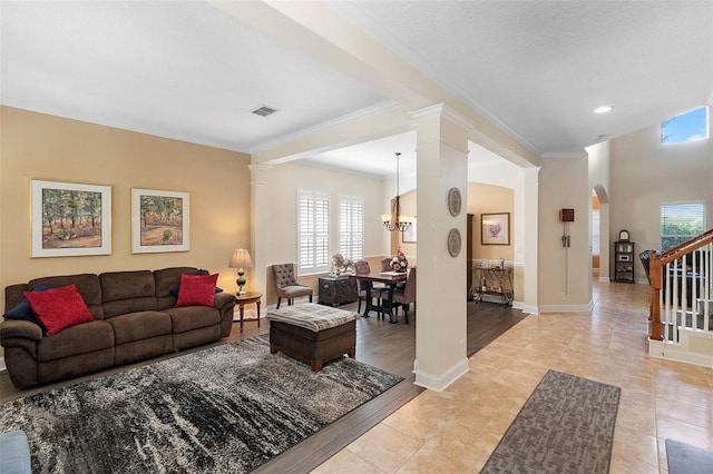 123 Ivydale Manor Dr, Deland, FL 32724 - living area with decorative columns, ornamental molding, a chandelier, arched walkways, and stairway