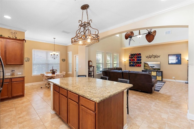123 Ivydale Manor Dr, Deland, FL 32724 - kitchen featuring a center island, crown molding, a chandelier, pendant lighting, and light tile patterned floors