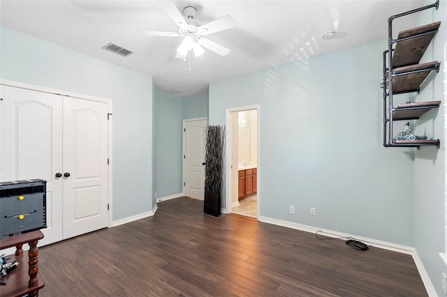 123 Ivydale Manor Dr, Deland, FL 32724 - unfurnished bedroom featuring dark wood-type flooring, baseboards, a closet, heating unit, and a ceiling fan