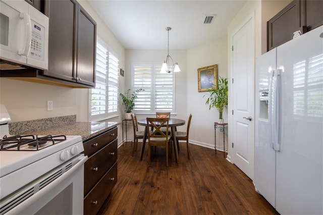 kitchen featuring white appliances, dark wood-style flooring, dark brown cabinetry, a chandelier, and hanging light fixtures