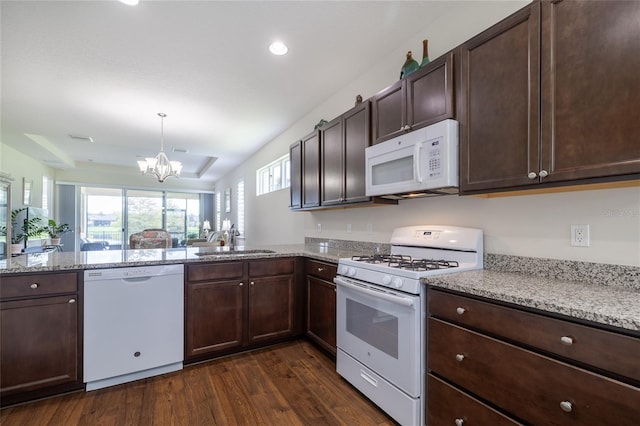 kitchen with white appliances, dark wood-type flooring, a chandelier, dark brown cabinetry, and recessed lighting