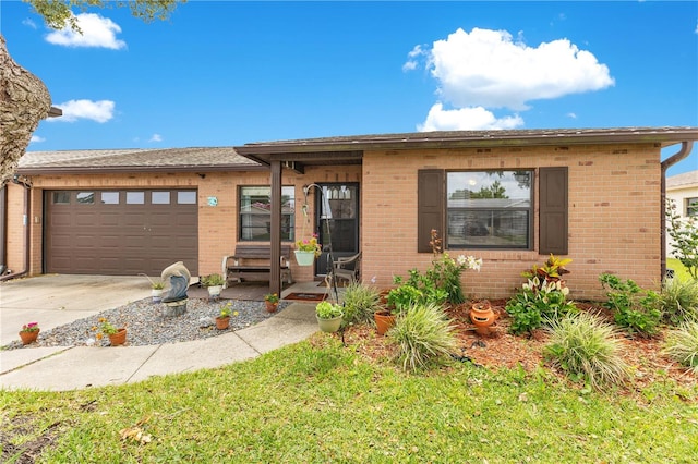 418 Falcon Ave, Edgewater, FL 32141 - ranch-style home with brick siding, a garage, and driveway
