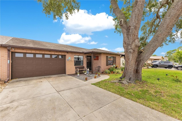 418 Falcon Ave, Edgewater, FL 32141 - view of front facade with brick siding, concrete driveway, an attached garage, and a front yard