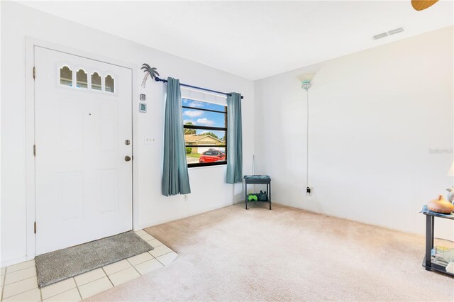 418 Falcon Ave, Edgewater, FL 32141 - foyer featuring carpet floors and tile patterned flooring