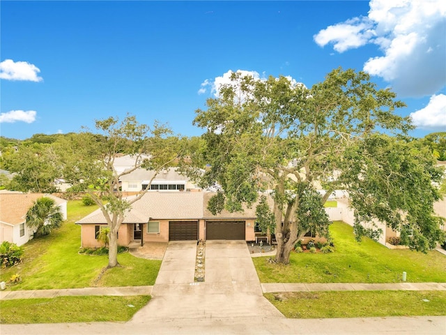 418 Falcon Ave, Edgewater, FL 32141 - mid-century home with driveway, stucco siding, and a front yard
