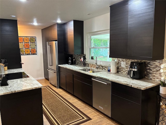 516 Hickorywood Ave, Altamonte Springs, FL 32714 - kitchen featuring appliances with stainless steel finishes, backsplash, light wood-style floors, dark cabinetry, and modern cabinets