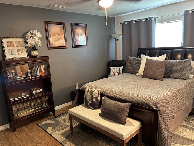 516 Hickorywood Ave, Altamonte Springs, FL 32714 - bedroom featuring wood finished floors, a textured ceiling, and ceiling fan