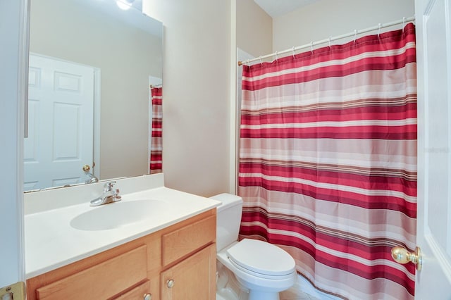 full bathroom featuring toilet, vanity, and a shower with curtain