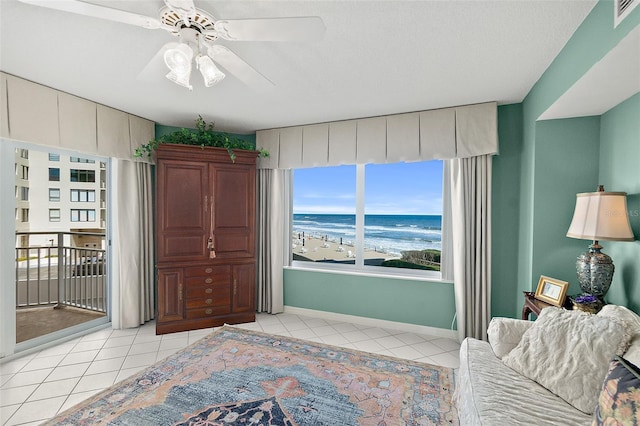 2967 S Atlantic Ave Unit 202, Daytona Beach Shores, FL 32118 - bedroom featuring light tile patterned flooring, a water view, a ceiling fan, baseboards, and access to exterior
