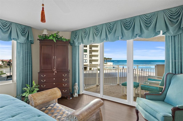 2967 S Atlantic Ave Unit 202, Daytona Beach Shores, FL 32118 - bedroom featuring access to outside, a water view, wood finished floors, and a ceiling fan