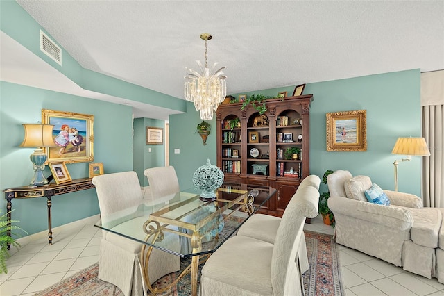 2967 S Atlantic Ave Unit 202, Daytona Beach Shores, FL 32118 - dining room with tile patterned floors, a chandelier, and a textured ceiling