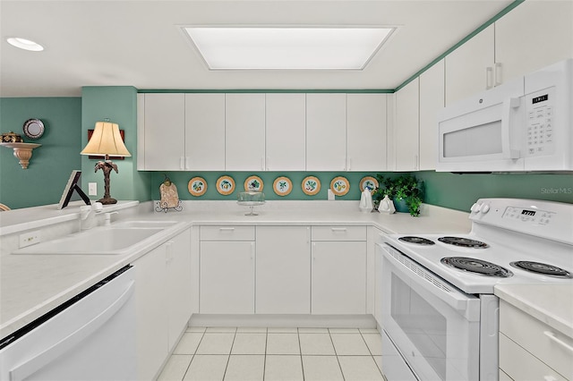 2967 S Atlantic Ave Unit 202, Daytona Beach Shores, FL 32118 - kitchen featuring white appliances, a sink, light tile patterned flooring, light countertops, and white cabinetry