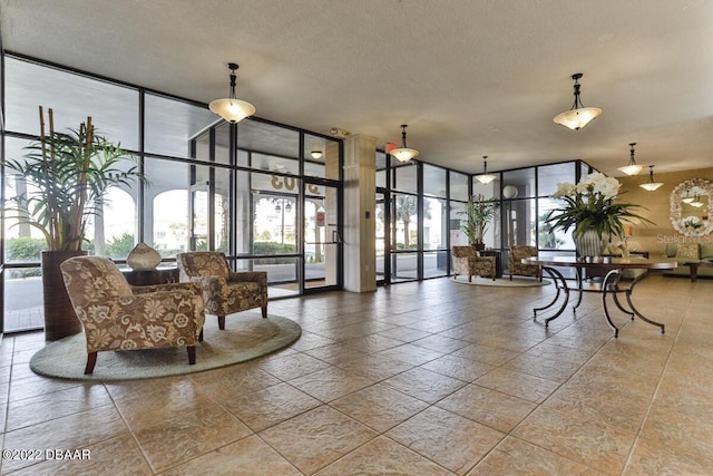 building lobby featuring floor to ceiling windows and a textured ceiling