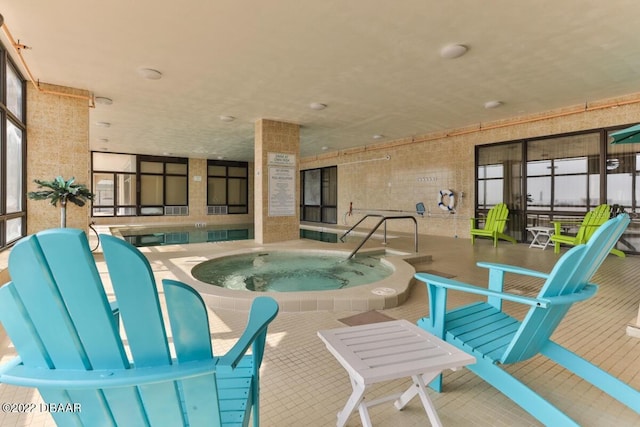 view of swimming pool with a hot tub